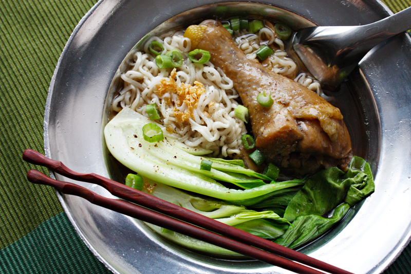 egg noodle soup with spiced broth, stewed chicken